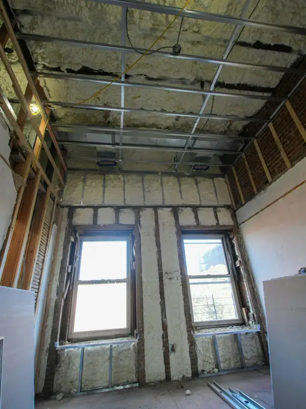 Renovated room with spray foam insulation around the windows
