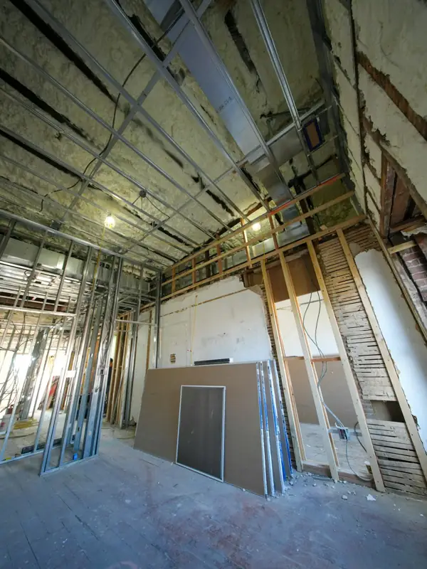 Long renovated hallway with insulation behind metal framing
