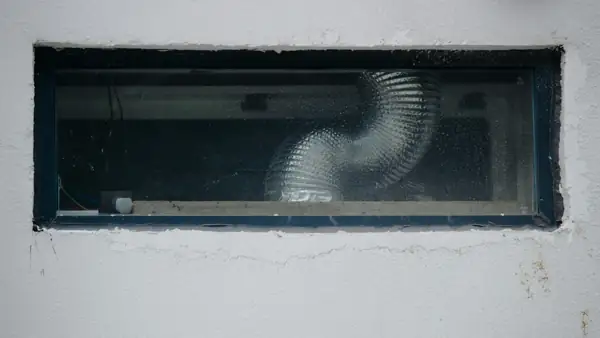 Flexible duct visible through an open ceiling access panel