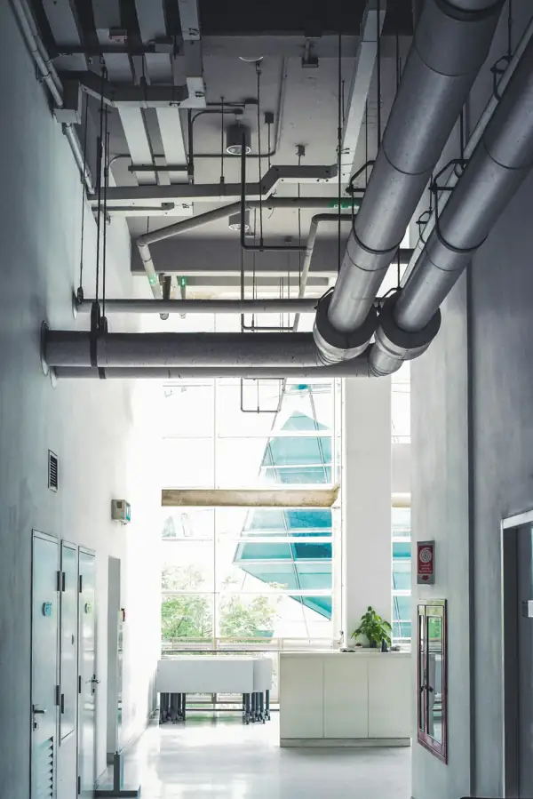 Insulated ducts and pipes running through a commercial corridor