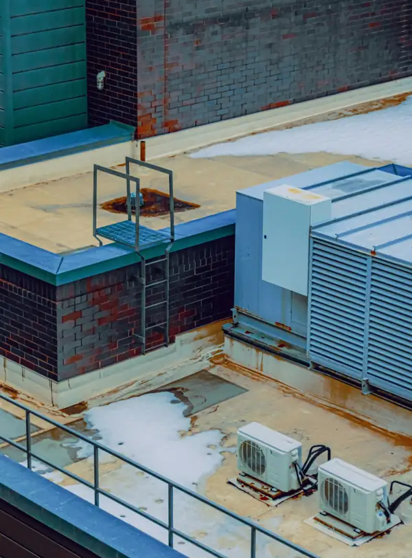 Rooftop HVAC unit with access ladder on a commercial building