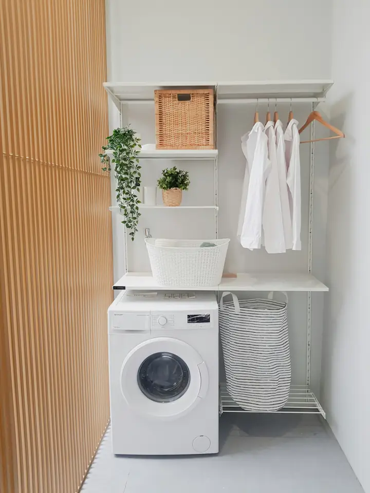 Compact laundry nook with a front-load washer and shelving
