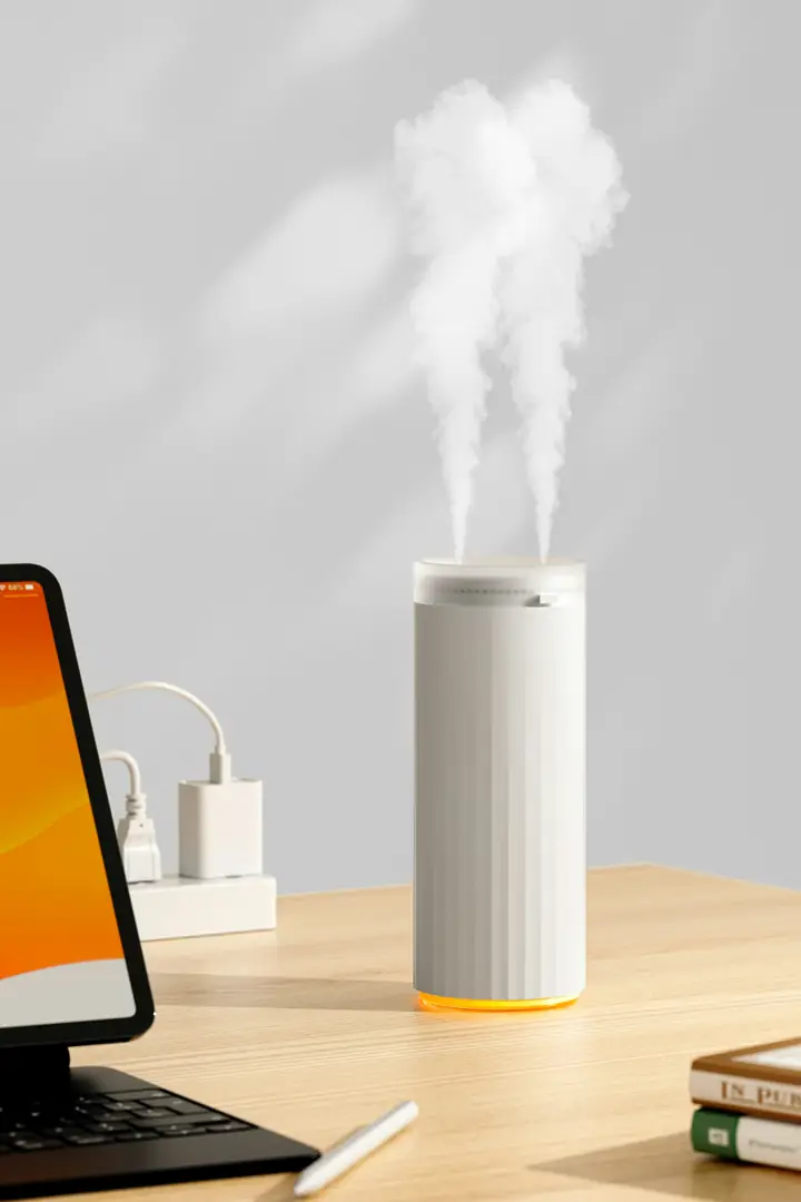 Air humidifier releasing mist on a desk
