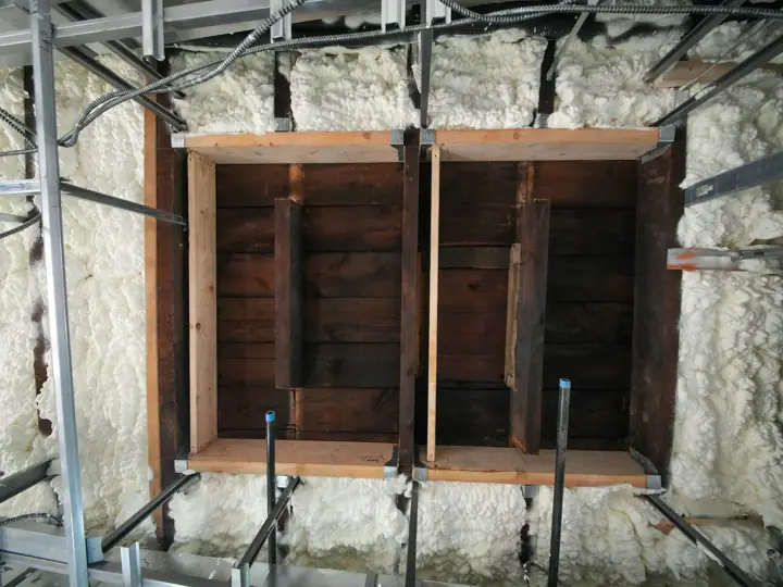 Fresh spray foam insulation in wall framing