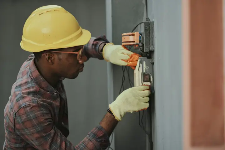 Technician testing equipment on a wall
