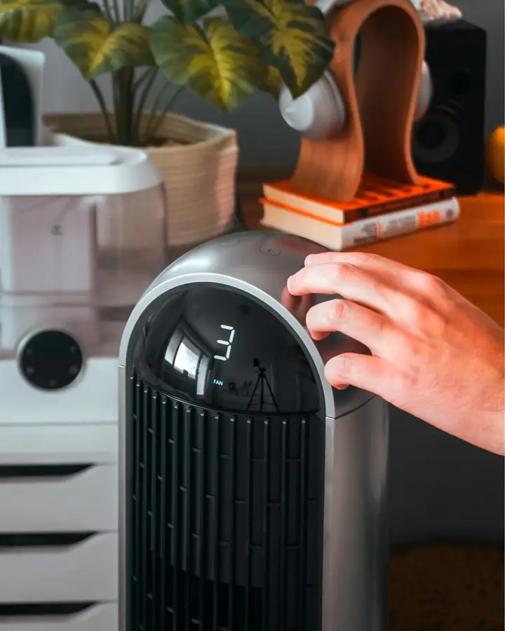 Hand adjusting a modern air purification device